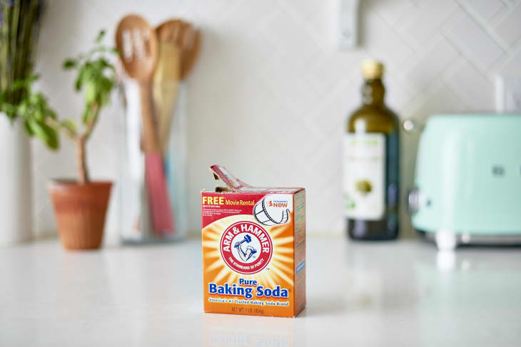 Arm & Hammer pure baking soda box on a white kitchen counter