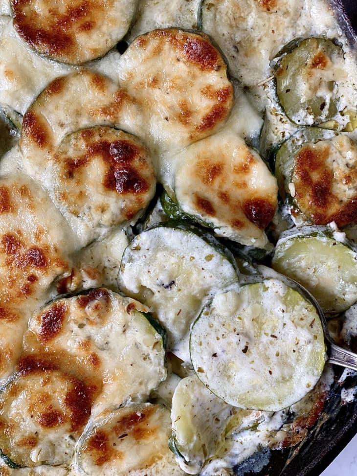 zucchini, parmesan, skillet, round zucchini slices, browned cheese, crispy top, creamy base, close up