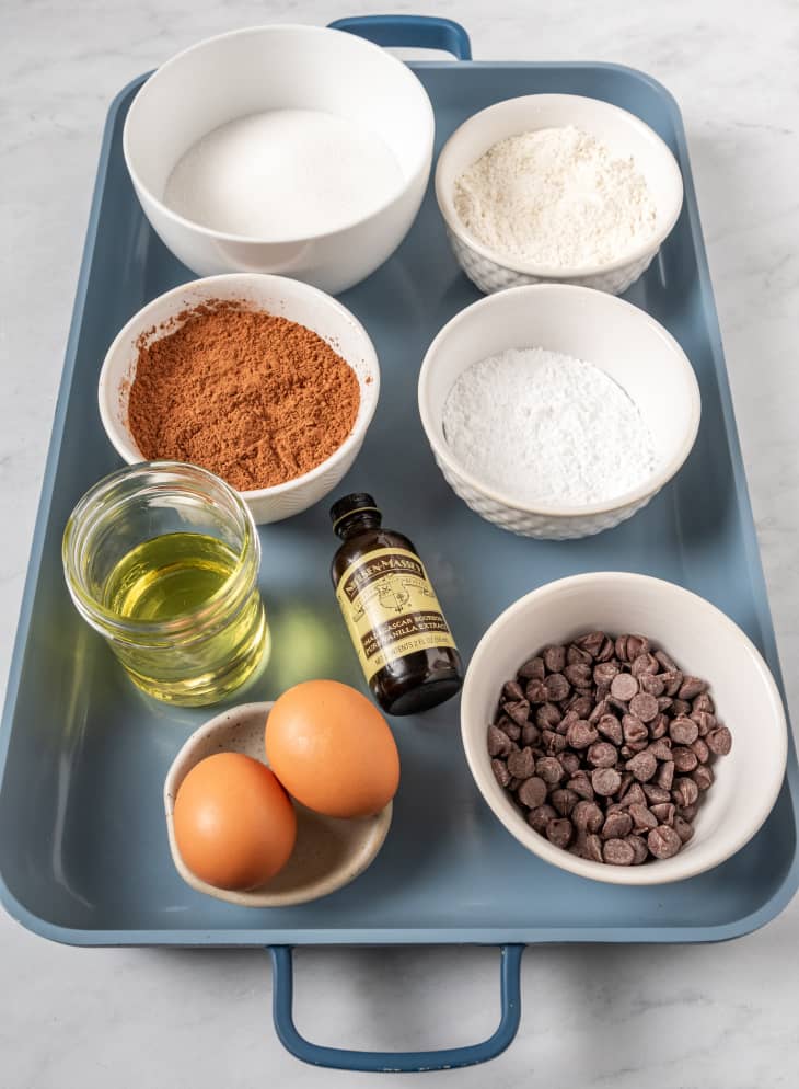 ingredients to make homemade brownies on a blue tray