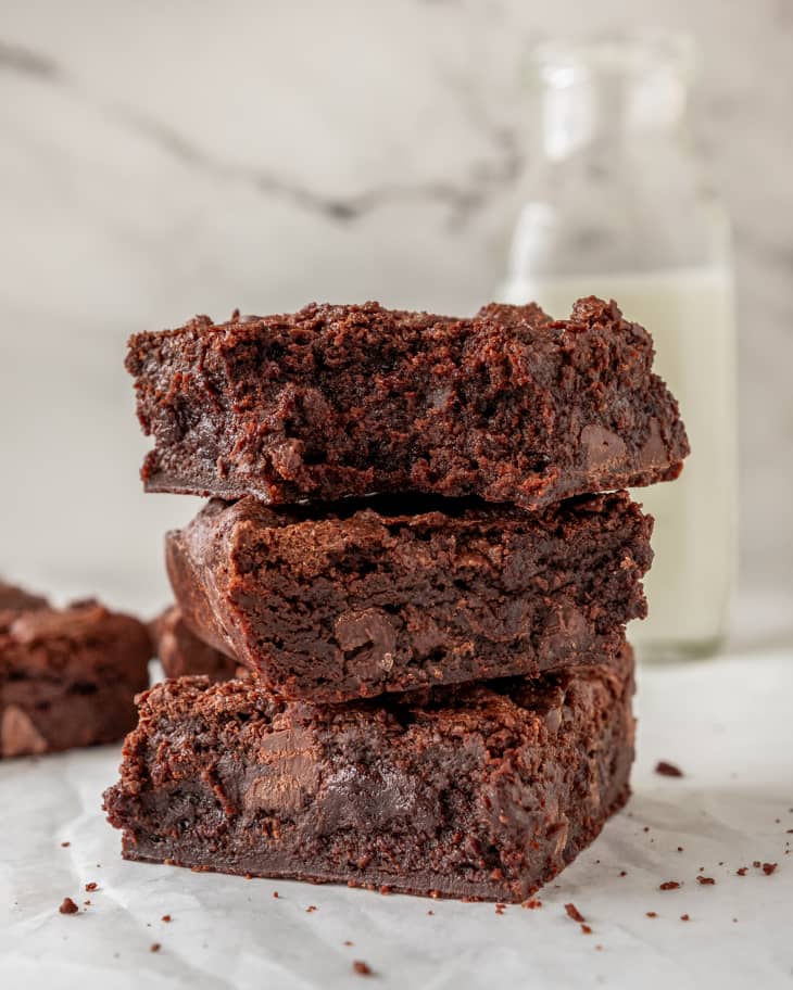 Stack of homemade brownies with a bottle of milk in the background