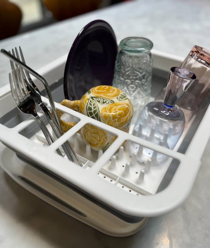 dish rack with draining tray filled with dishes