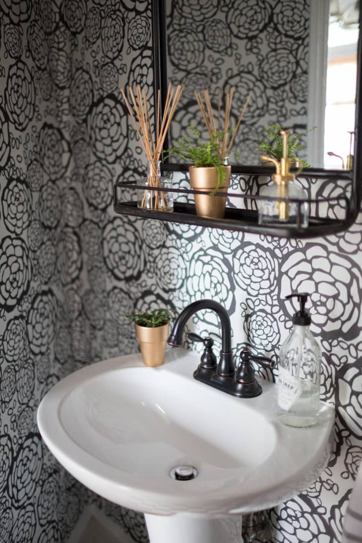 Powder room with black and white graphic flower wallpaper