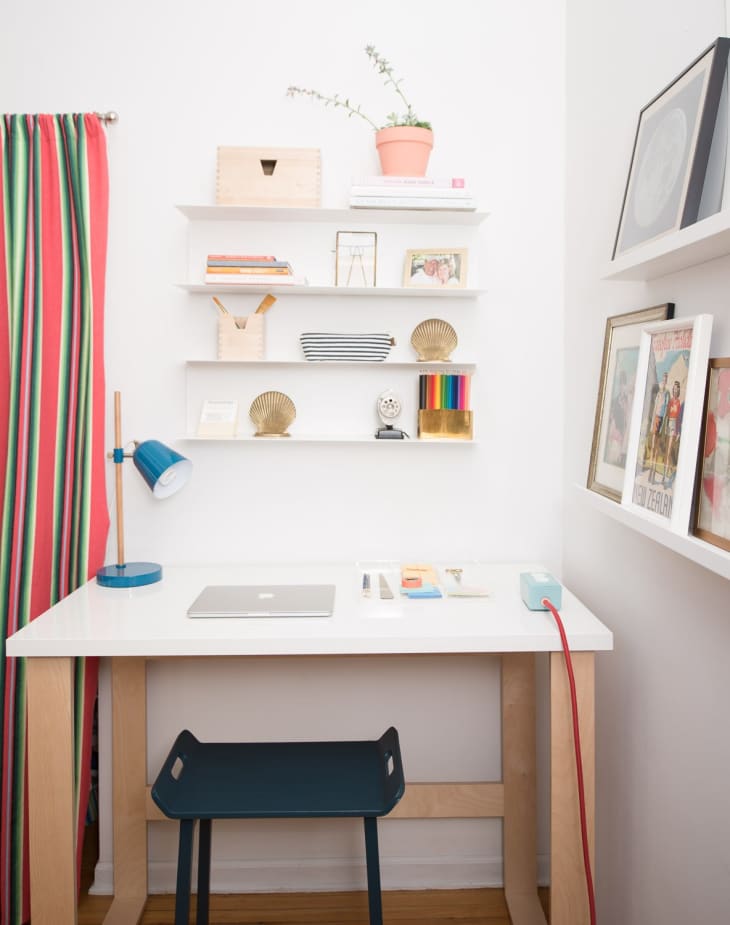 floating shelves above small desk