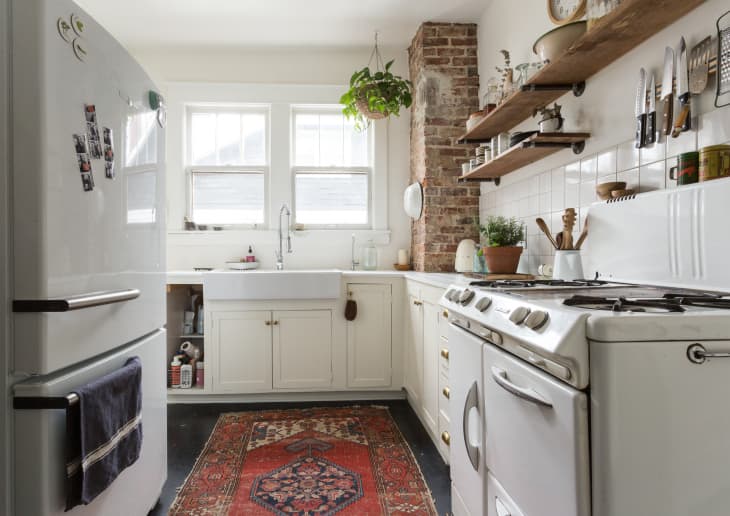 A low-pile, patterned rug offers texture and color, and brings visual warmth to the kitchen