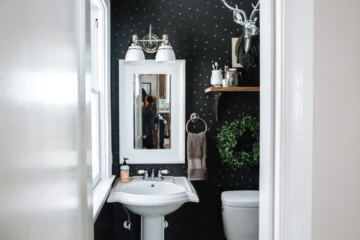 Half bath with black polka dot accent wall