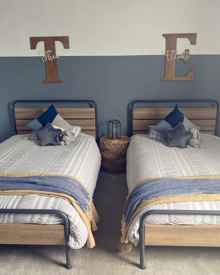 a rustic bedroom for twin boys features two beds side by ride