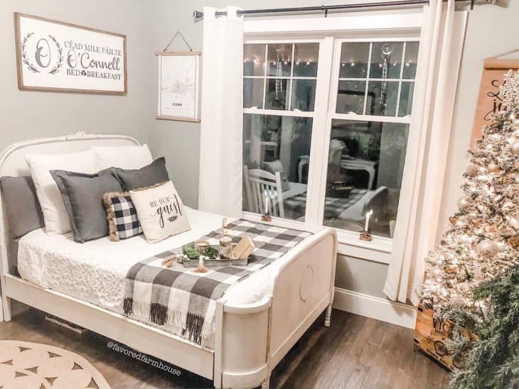 rustic bedroom with black and white checkered throw blanket and pillow on the bed