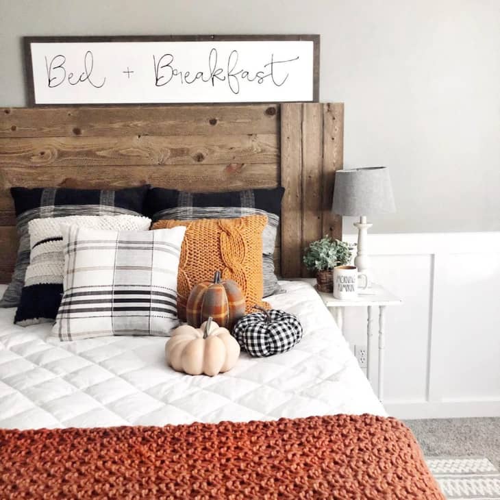 a rustic bedroom is decorated with black white and orange accents