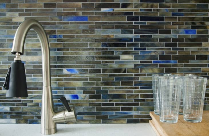 sink area in kitchen with glass mosaic tiles