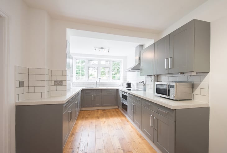 A general view of a grey fitted kitchen within a home