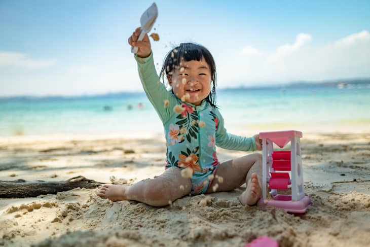 Baby girl playing on beach