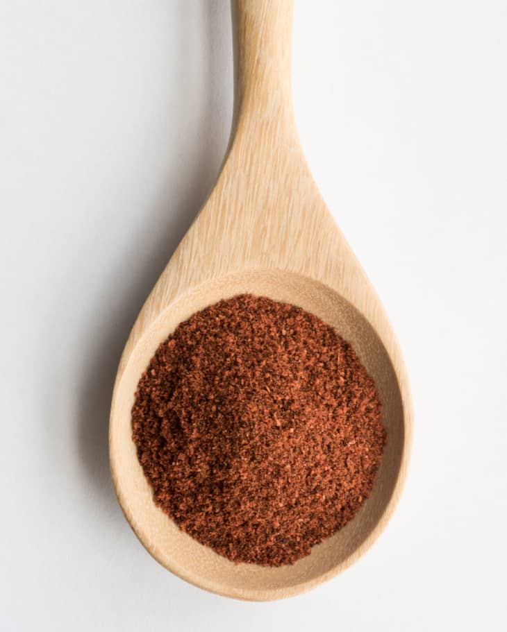 wooden spoon full of ground chipotle chili powder
