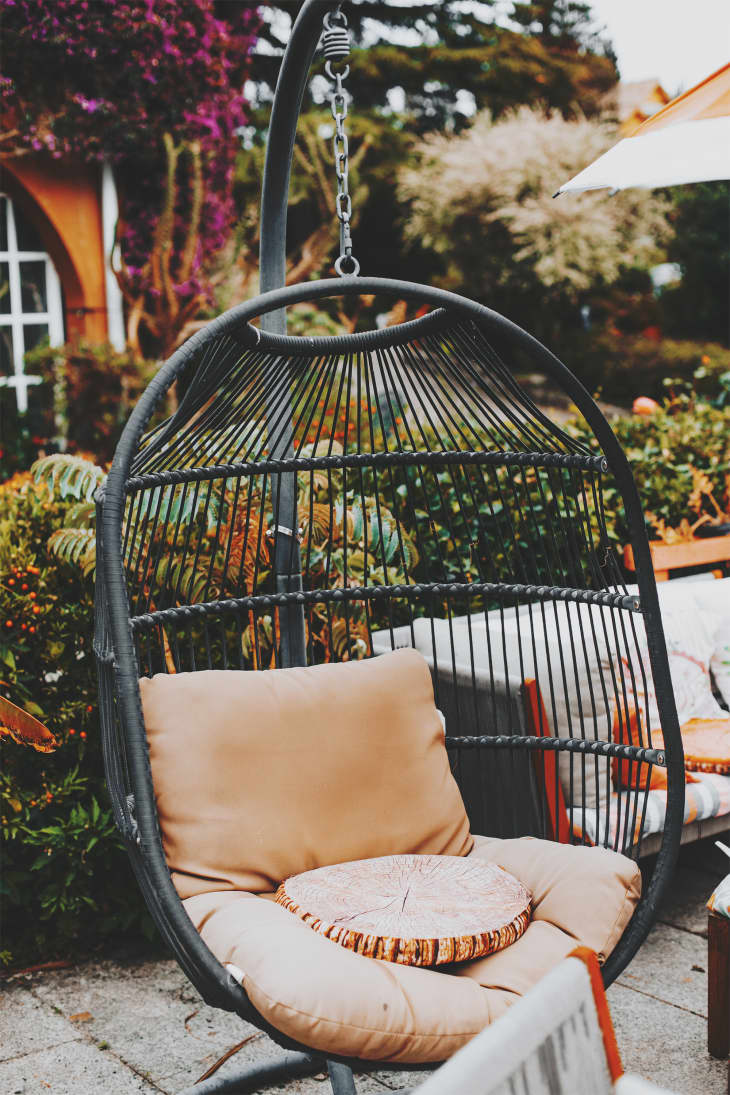 Green metal garden furniture in a small garden.