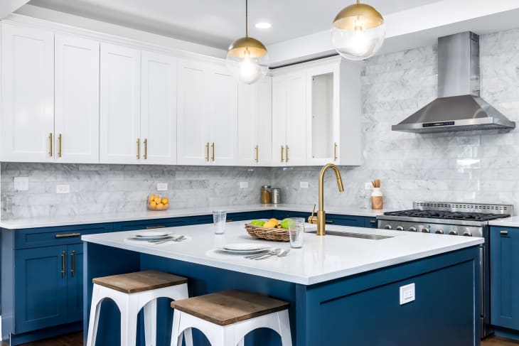 A blue and white kitchen with gold accents