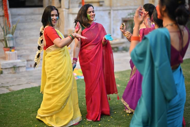 Indian women dancing with each other and celebrating Holi festival. Holi is a famous Hindu traditional festival, it is a festival of colors celebrated in every part of India