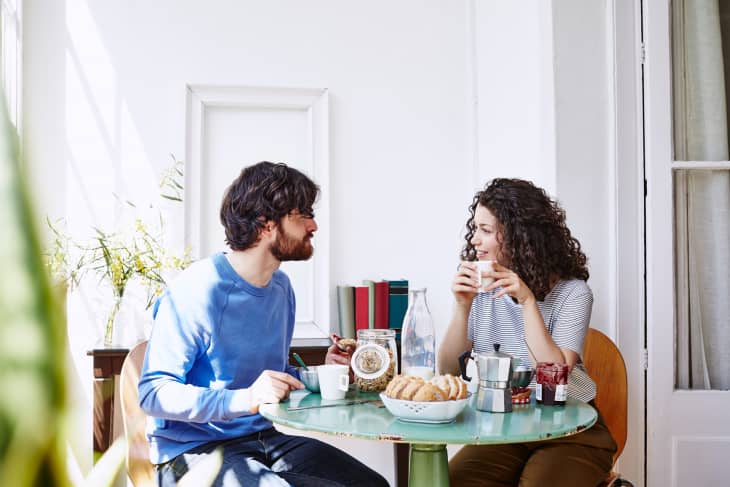 Couple Talking While Having Breakfast At Home