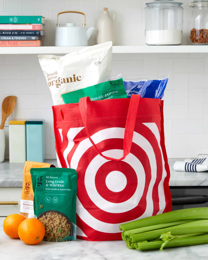someone taking target groceries out of target bag in a kitchen setting