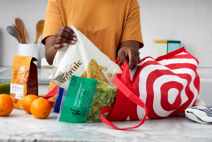 someone taking target groceries out of target bag in a kitchen setting