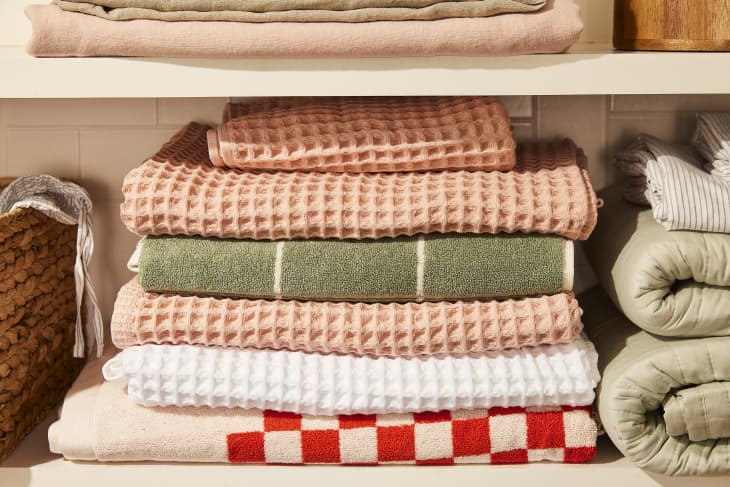 different colors and textures of towels, sheets, blankets, folded in linen closet