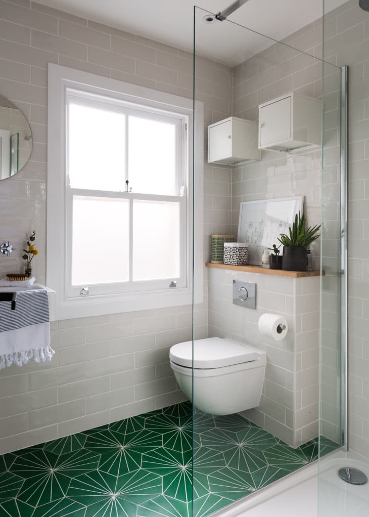 A bathroom with cool triangular tiles in a floral pattern.