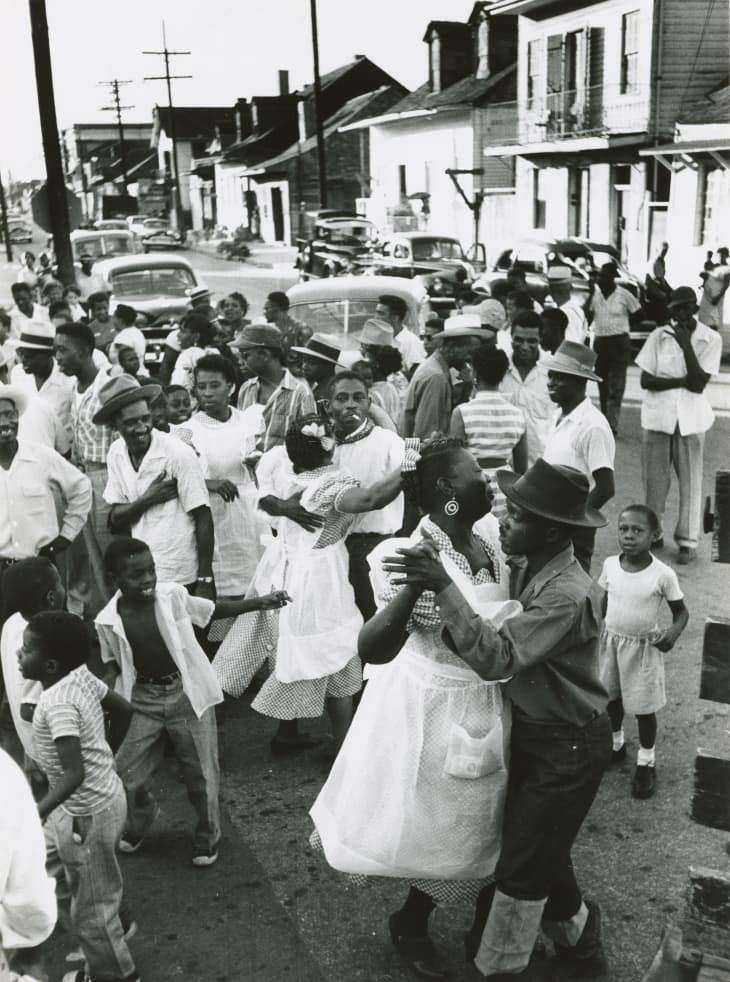 People dancing in the street in the Treme. Caldonia Club advertisement.