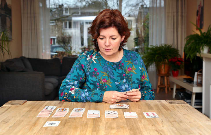 Woman playing solitaire at home