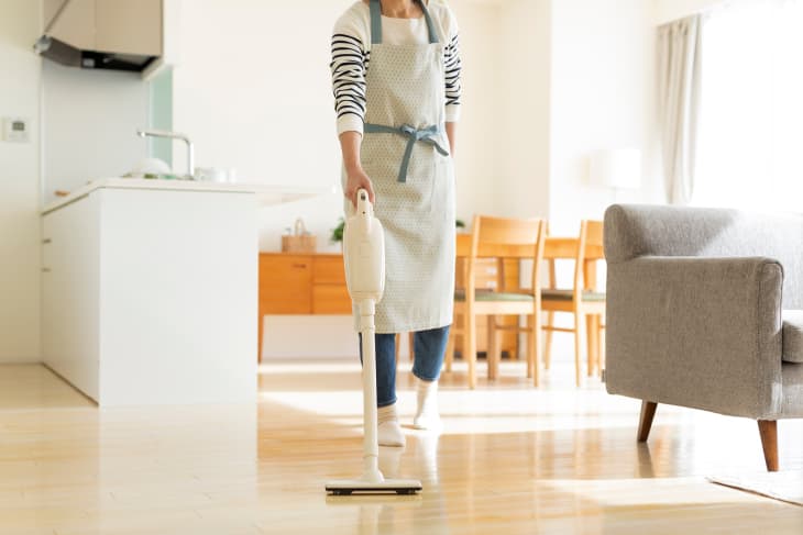 Woman vacuuming kitchen