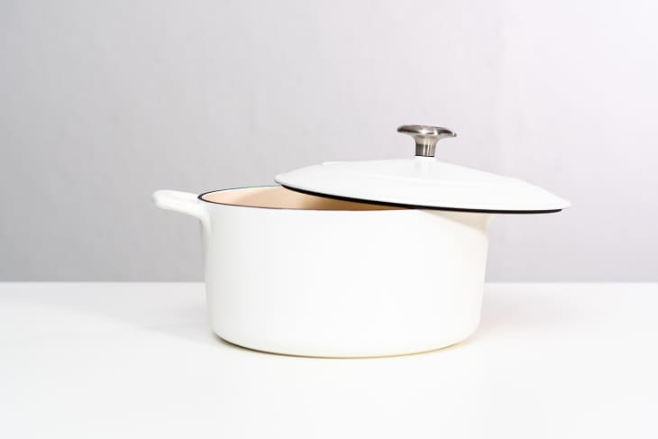 White enameled cast iron covered round dutch oven on a white background.