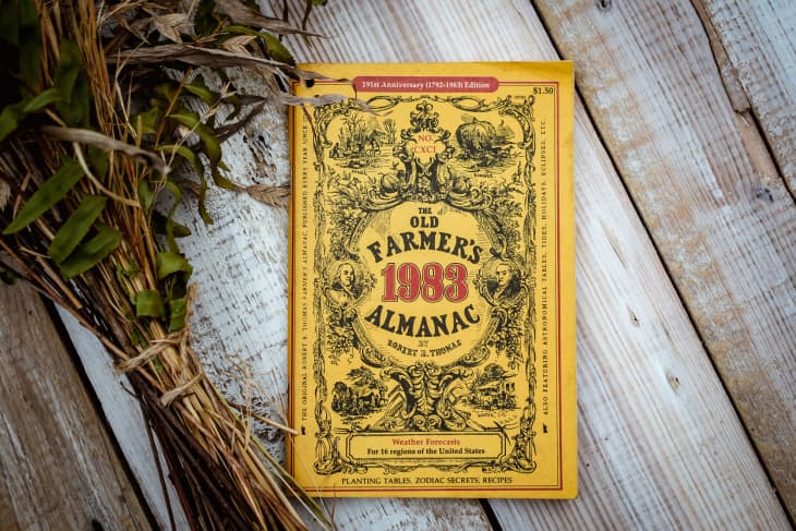 Black Fork, Arkansas, USA- September 1, 2020- A vintage 1983 yellow farmers almanac sitting on top of a table with some dried flowers beside it