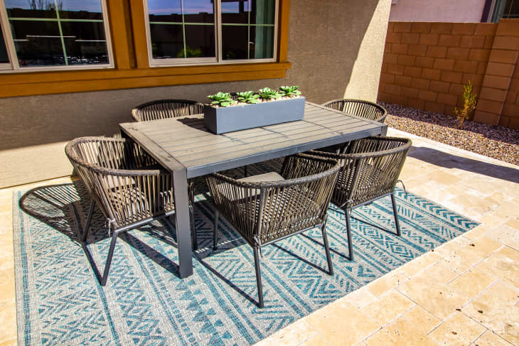 Rear Patio Table With Centerpiece And Six Rattan Chairs