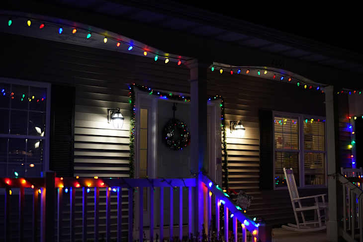 Columbia, Missouri, United States of America. December 21st, 2022. Front porch of a house decorated with Christmas lights at night.