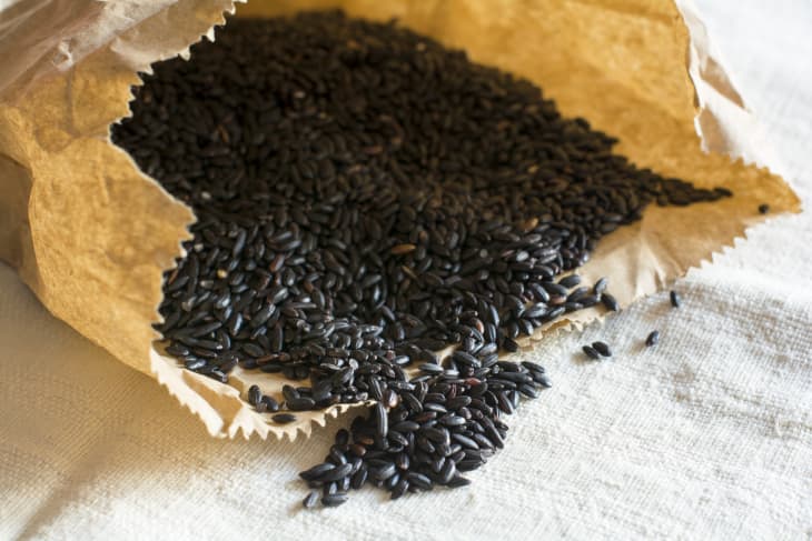 black rice pouring out of a bag