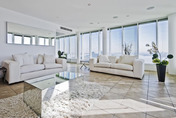 living room with floor to ceiling windows and modern furniture