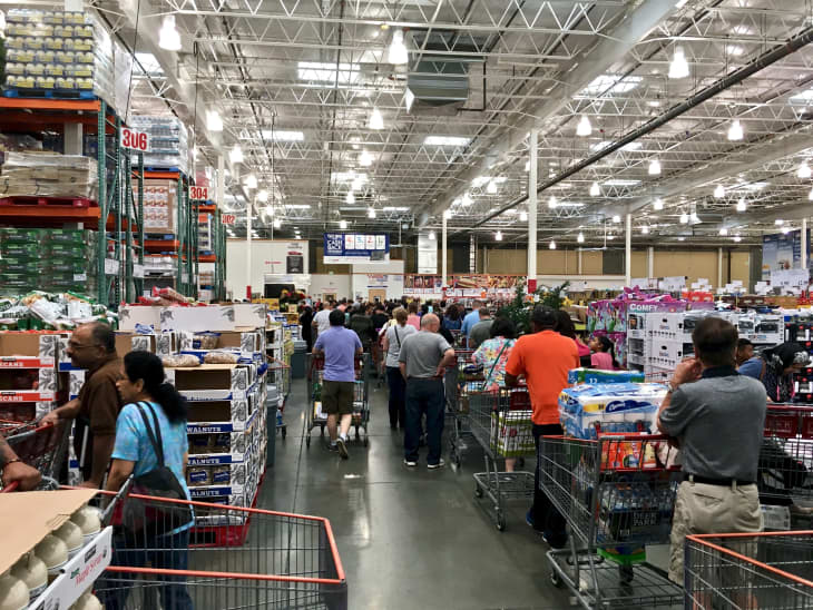 ELKRIDGE, MD, USA - APRIL 30, 2017: Costco Wholesale showing a large influx of shoppers, creating a checkout line that stretches halfway back though the store.