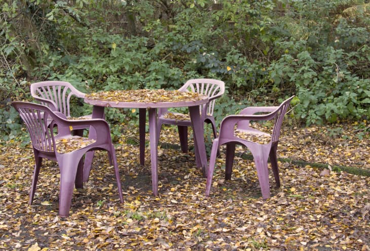 Plastic patio furniture with autumn leaves