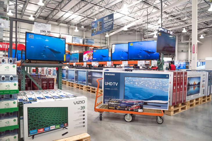 HUMBLE, TX, US-NOV 25, 2016: Costco Wholesale with row of big screen, smart TVs display on shelves and on flatbed cart. Largest membership-only warehouse club in US with total of 705 stores worldwide
