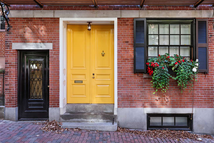 Yellow front door to classic style home