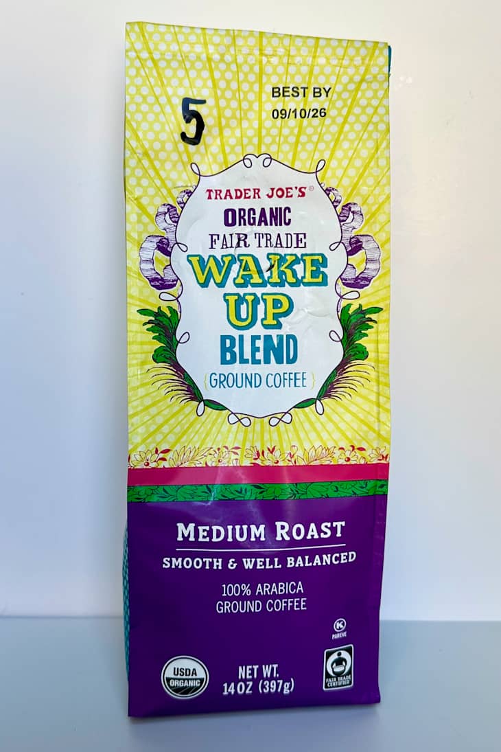 Ground coffee bag featuring Trader Joe's Organic Fair Trade Wake Up Blend, with bright yellow and purple design.