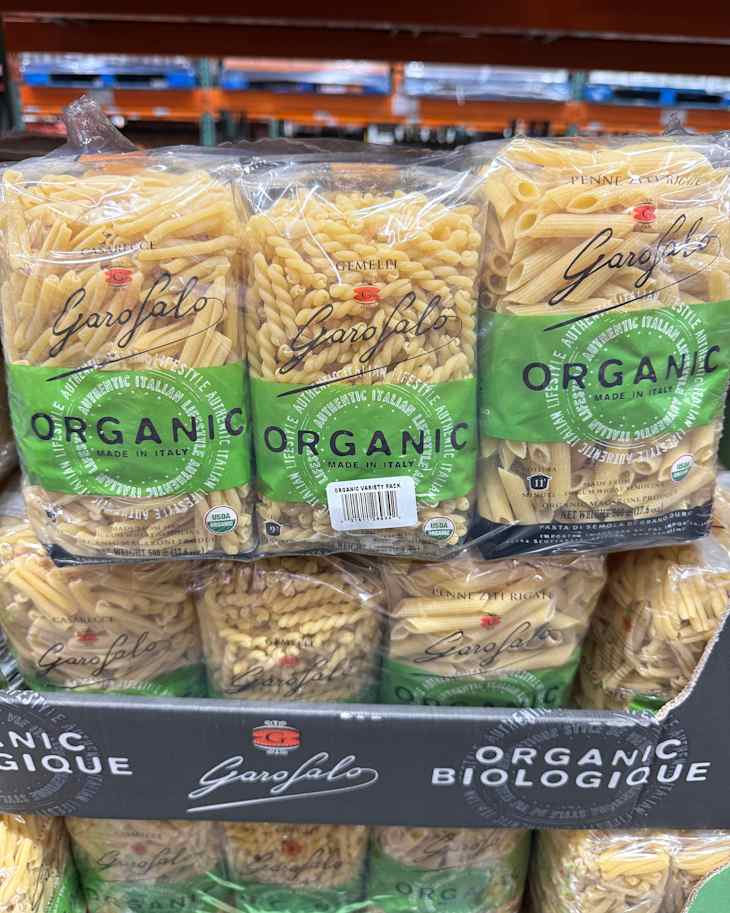 Three types of Garofalo organic pasta packages stacked on a display, featuring casarecce, gemelli, and penne rigate.