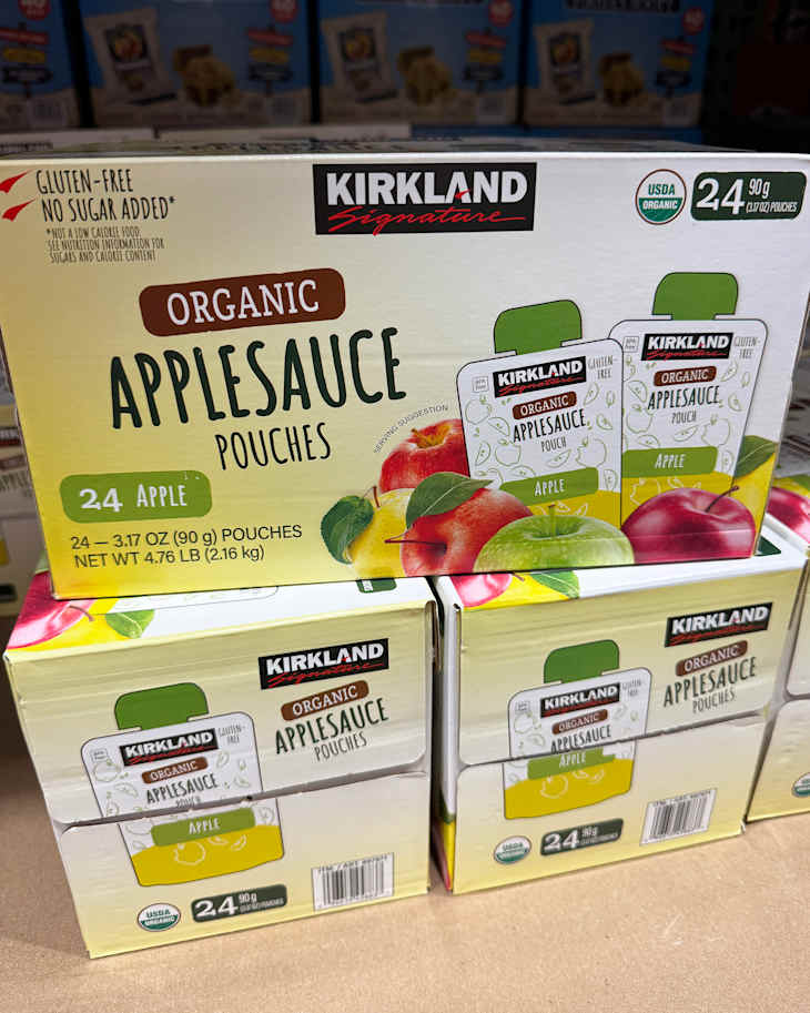 Organic applesauce pouches in a box, featuring 24 individual servings with apple graphics and nutritional labels.