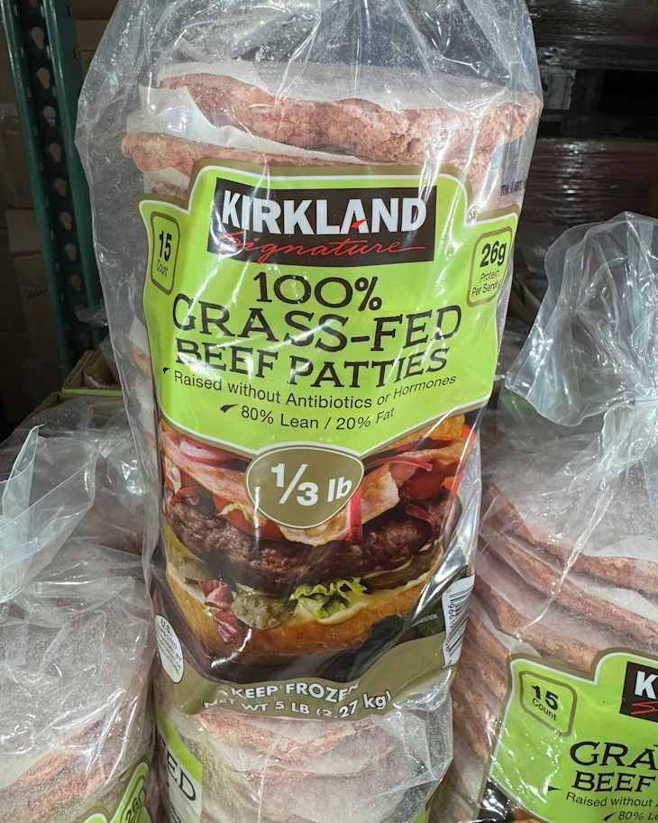Frozen package of Kirkland 100% grass-fed beef patties, 15 count, labeled 80% lean, 20% fat, and antibiotic-free.