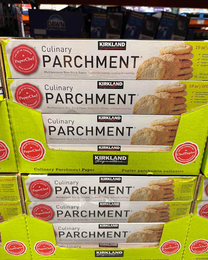 Culinary parchment paper boxes stacked, featuring cookies on the packaging, labeled with Kirkland and PaperChef.