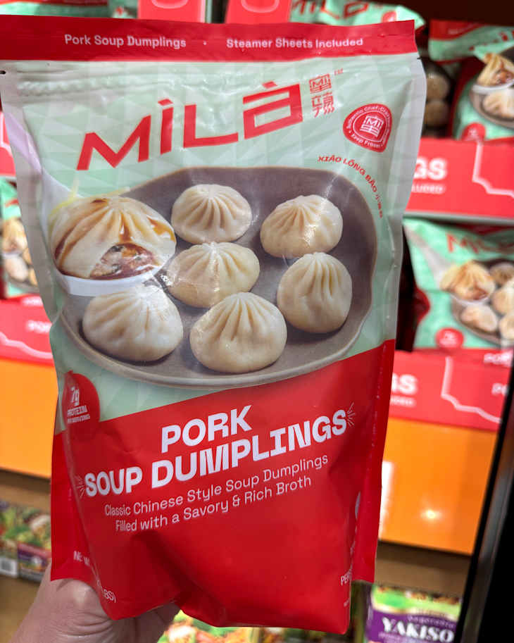Pork soup dumplings package featuring six dumplings on a plate, with steamer sheets included.