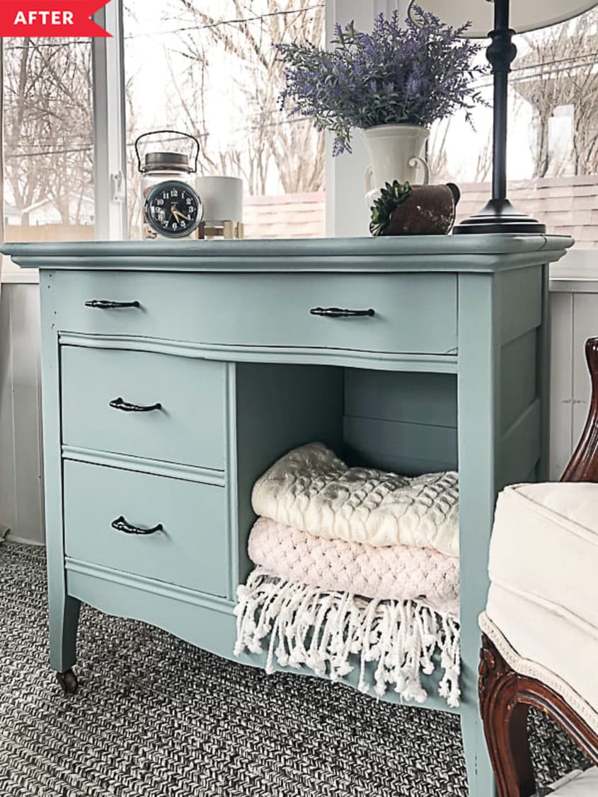 After: Painted blue dresser with folded blankets in open cubby