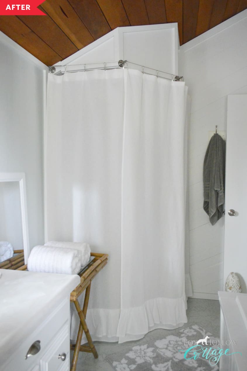 After: Shower with vaulted ceiling, white walls, and white shower curtain