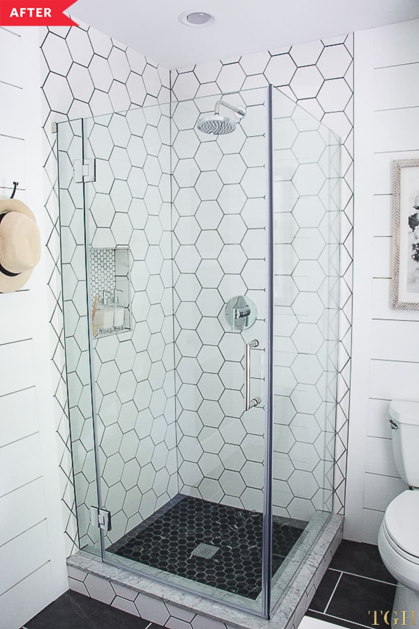 After: White shower with oversized hex tile and glass doors