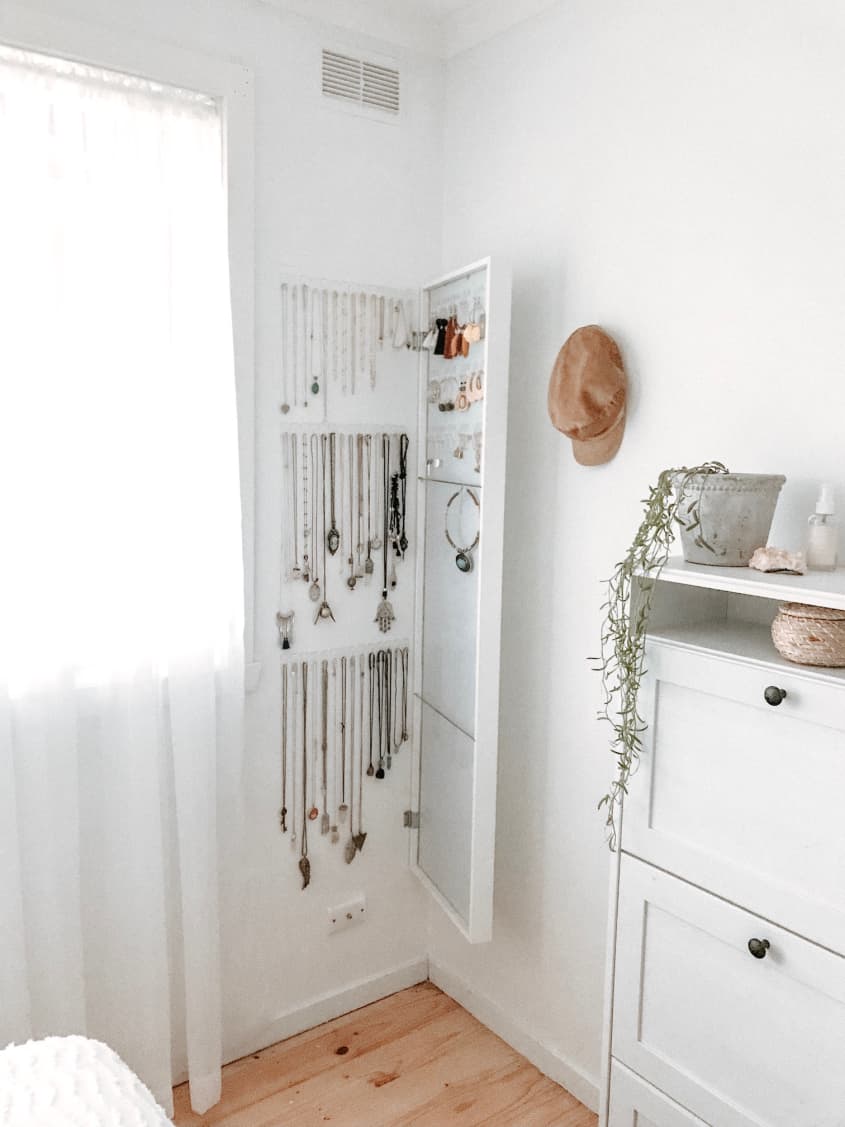 IKEA wall mirror with white frame, opened to reveal jewelry storage behind