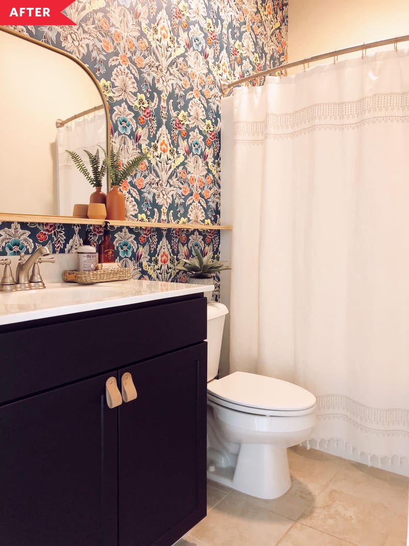 After: bathroom with black vanity, colorful patterned wallpaper, and a shelf for the mirror