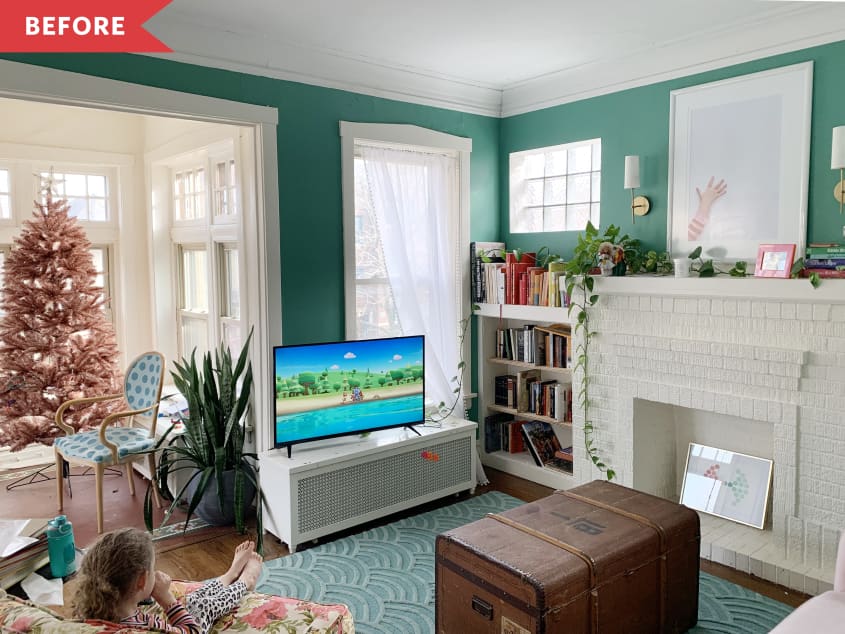 Living room before: TV next to fireplace, with art above fireplace
