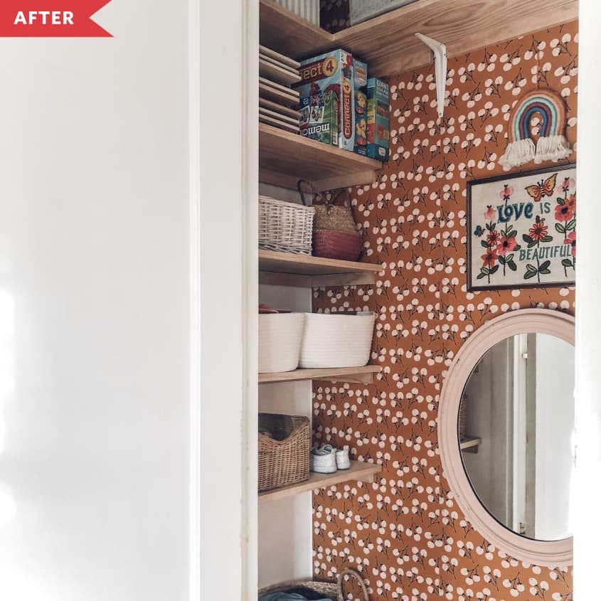 After: Orange floral wallpapered closet with shelves on the left side going up the wall and a mirror in the center